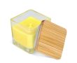 Bougie en cire végétale dans un pot en verre avec couvercle en bambou couleur jaune