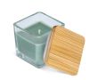 Bougie en cire végétale dans un pot en verre avec couvercle en bambou couleur vert olive