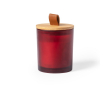 Bougie dans un pot en verre coloré couleur rouge